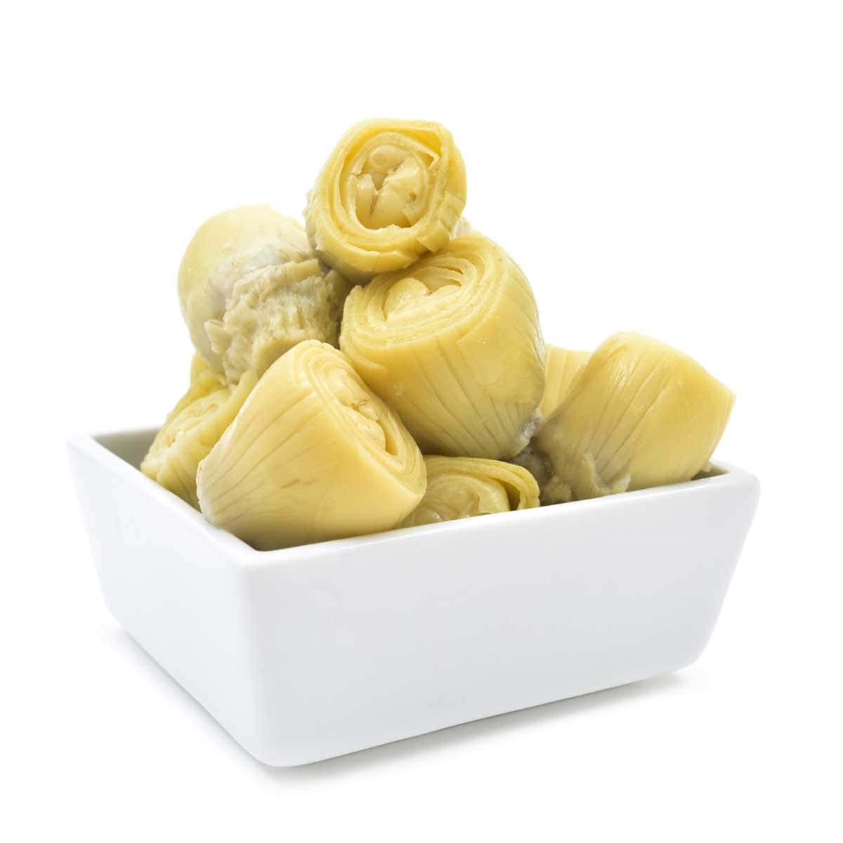Bacon dip ingredients A dozen artichoke hearts in a white dish.