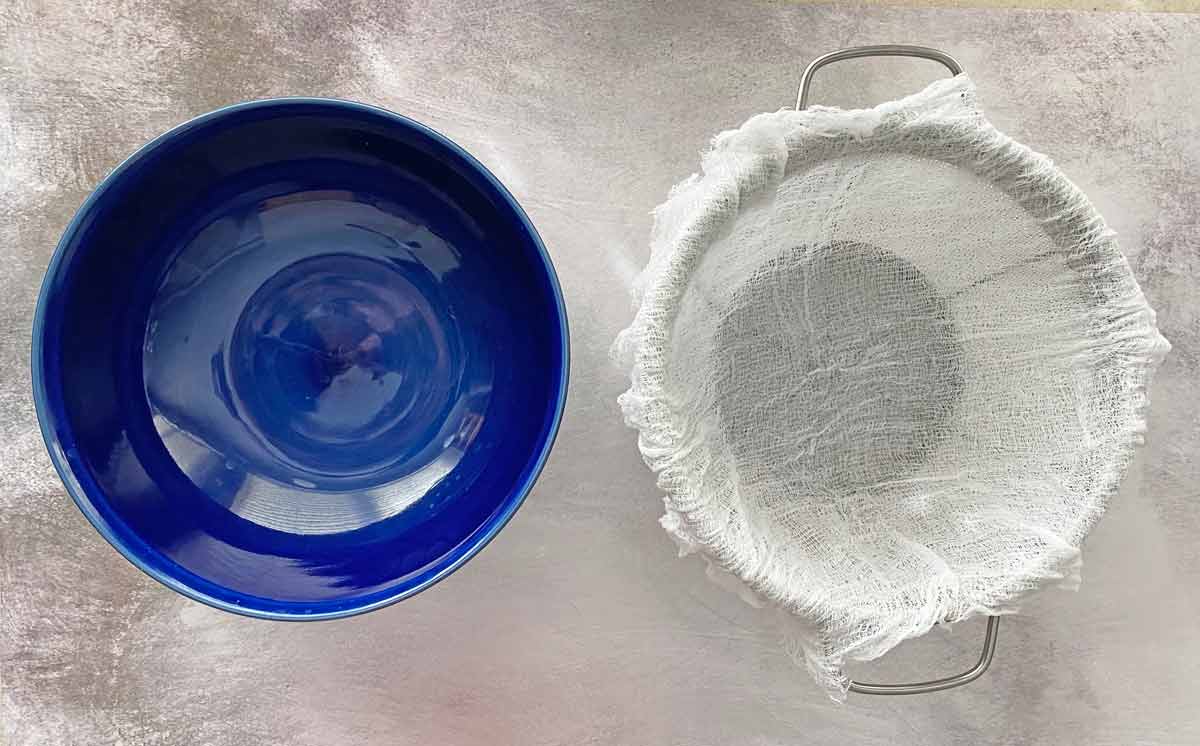 yogurt7 A blue bowl and a strainer lined with cheesecloth.
