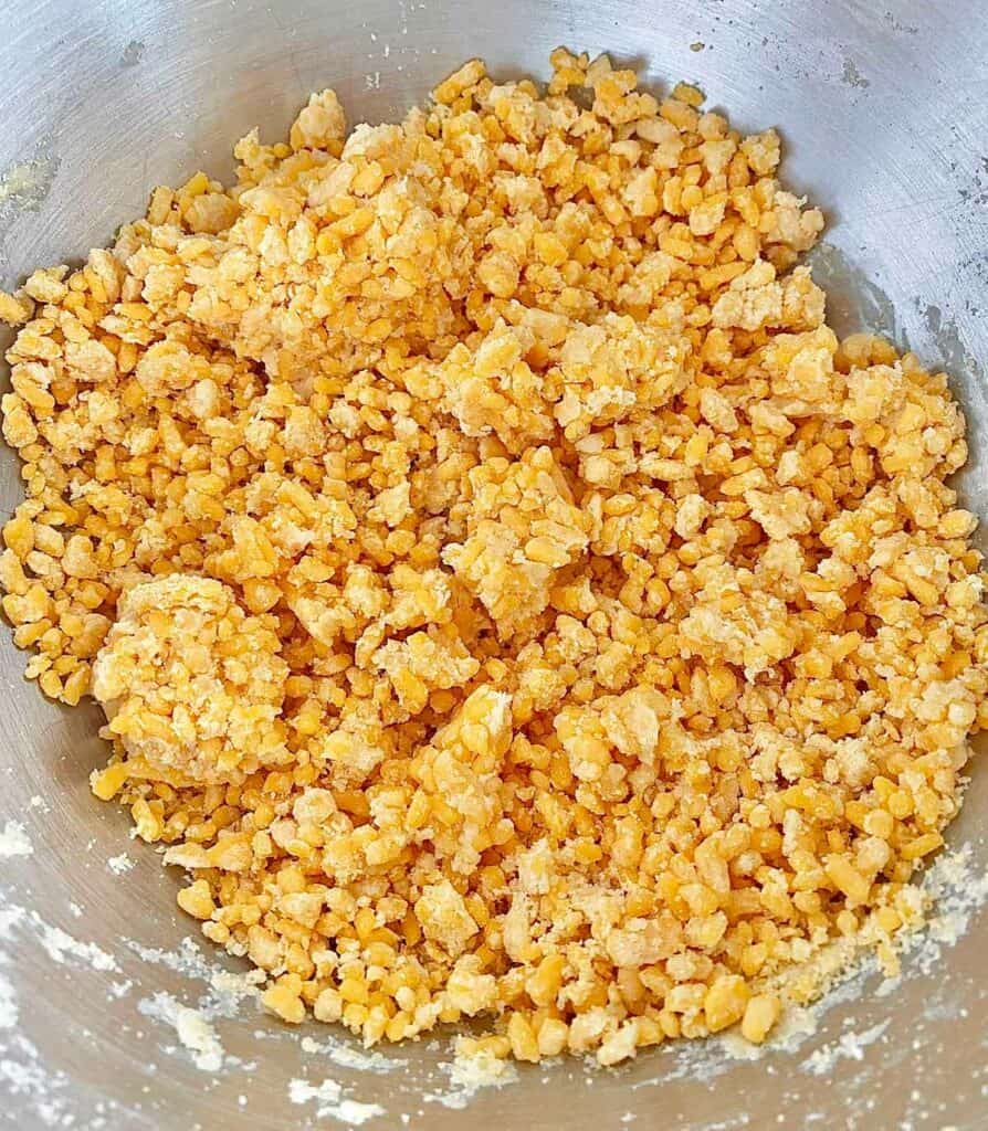 Crackers4 Adding ice water to homemade cheese cracker dough.