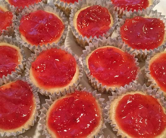 strawberry jam on mini cheesecakes