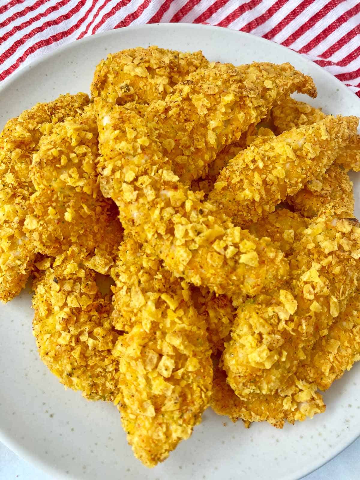 Cool ranch Doritos chicken piled on a white serving plate.