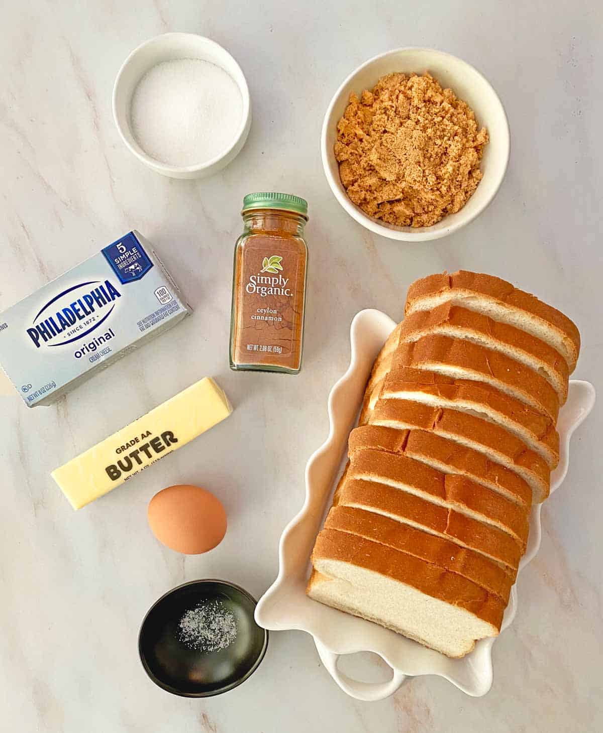 Sugar, brown sugar, cinnamon, cream cheese, butter, 10 bread slices, an egg and a small dish of salt.