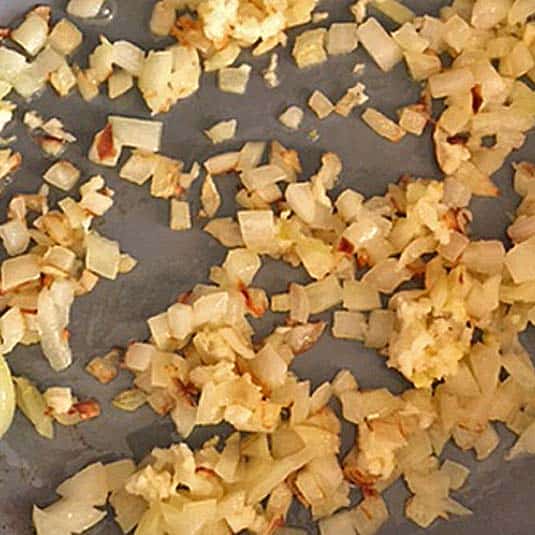 Cooking onion and garlic in a skillet.