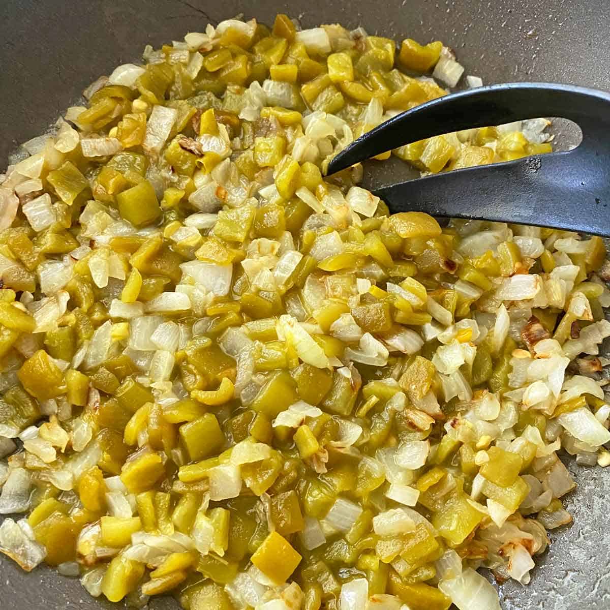 DSC_0742 Cooking chopped onions and green chiles in a skillet.