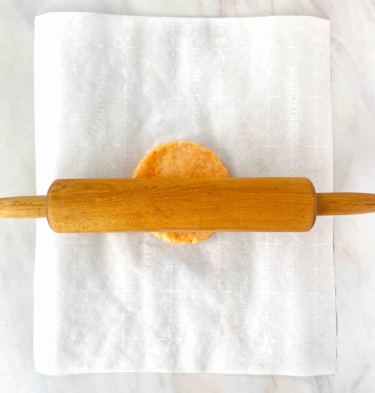 Crackers7 Beginning to roll cheese cracker dough with a wood rolling pin.