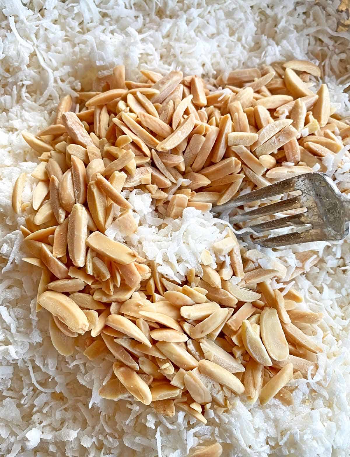 Stirring toasted almonds into the coconut flour mixture for macaroons.