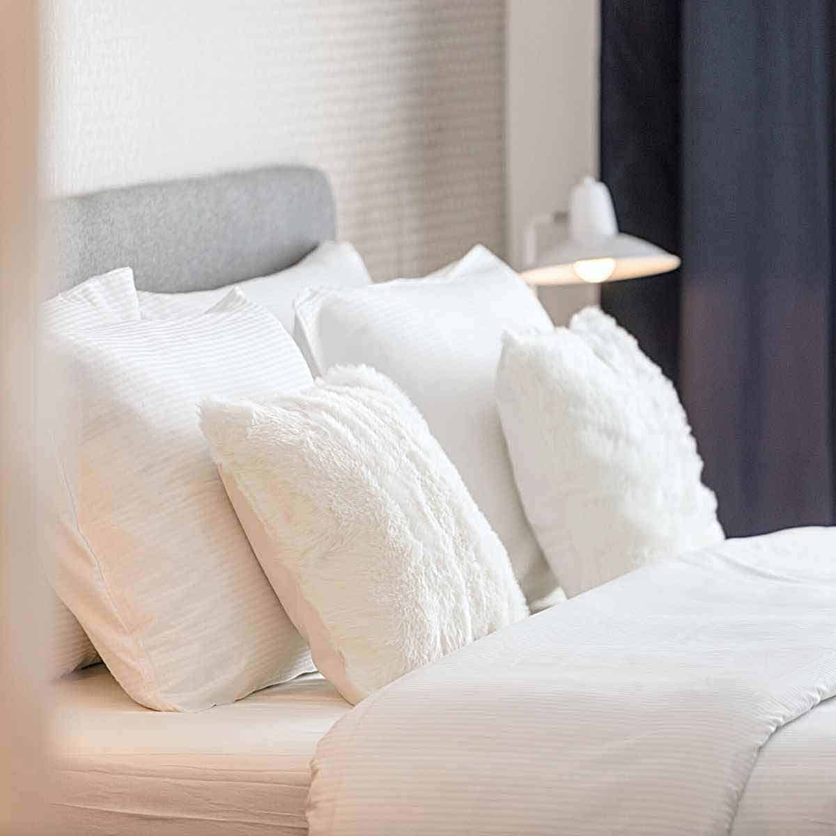 A bed made up with top quality sheets.